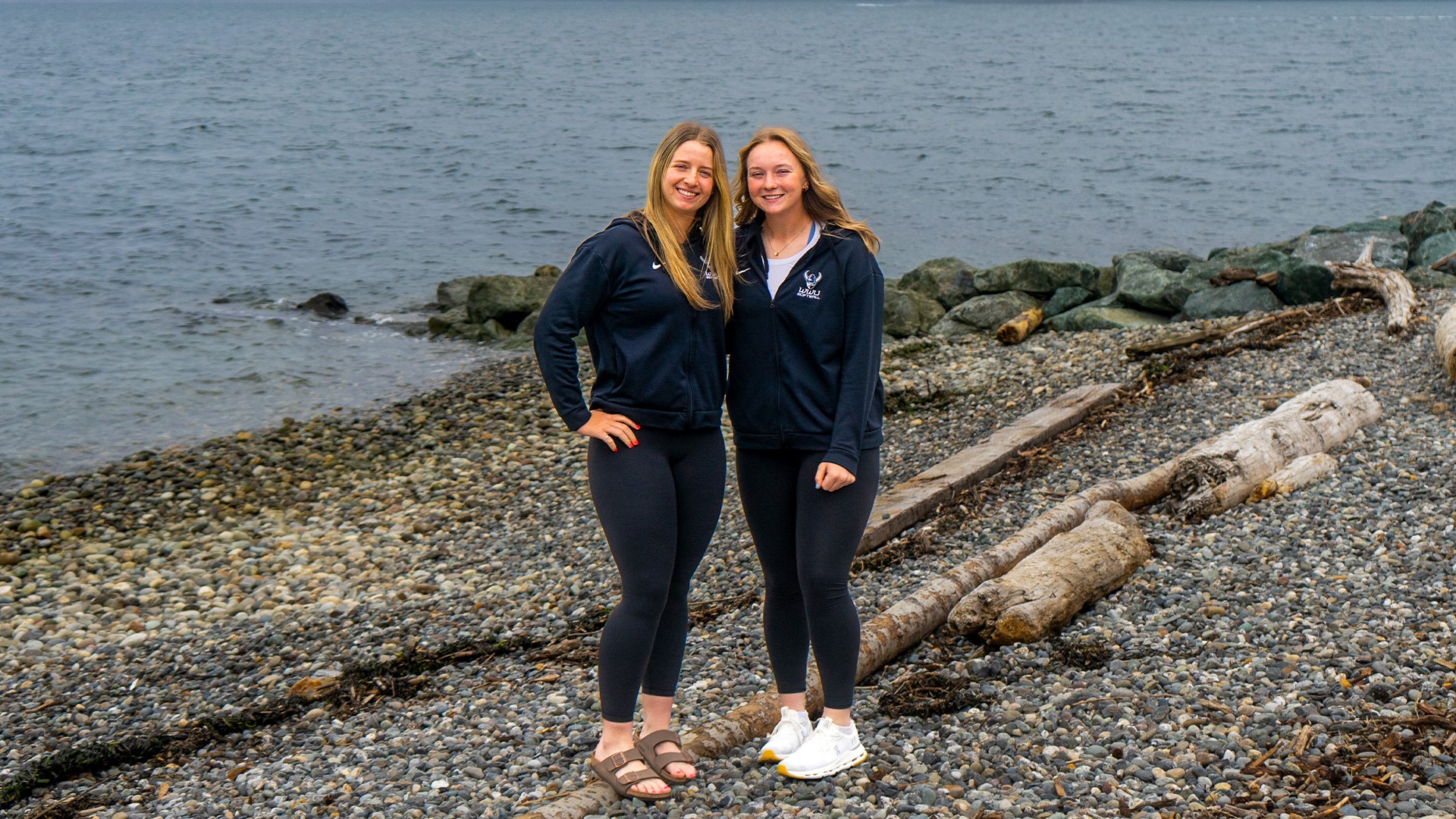 Hailey Rath and Olivia Matlock | Photo of two WWU Softball players on a beach with water in the background