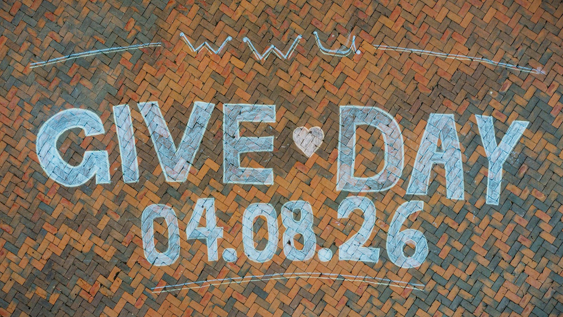 Chalk art on brick pavement spells 