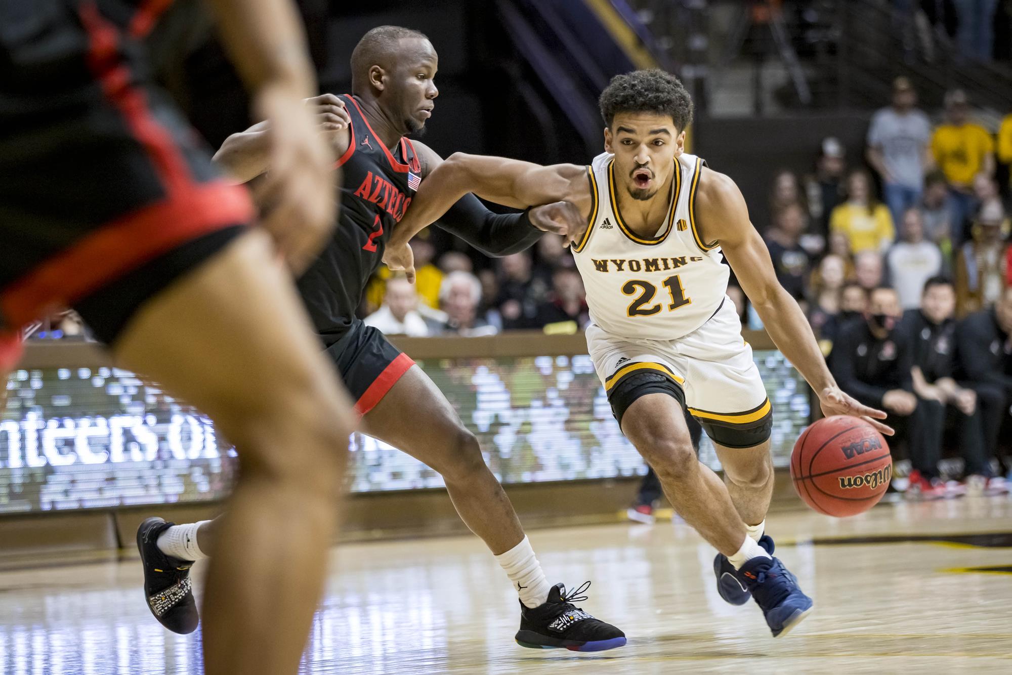 Feb 28, 2022; Laramie, Wyoming, USA; Wyoming Cowboys guard Noah Reynolds (21) against San Diego State Aztecs guard Lamont Butler (5) during the second half at Arena-Auditorium. Mandatory Credit: Troy Babbitt-USA TODAY Sports - Wisconsin Badgers