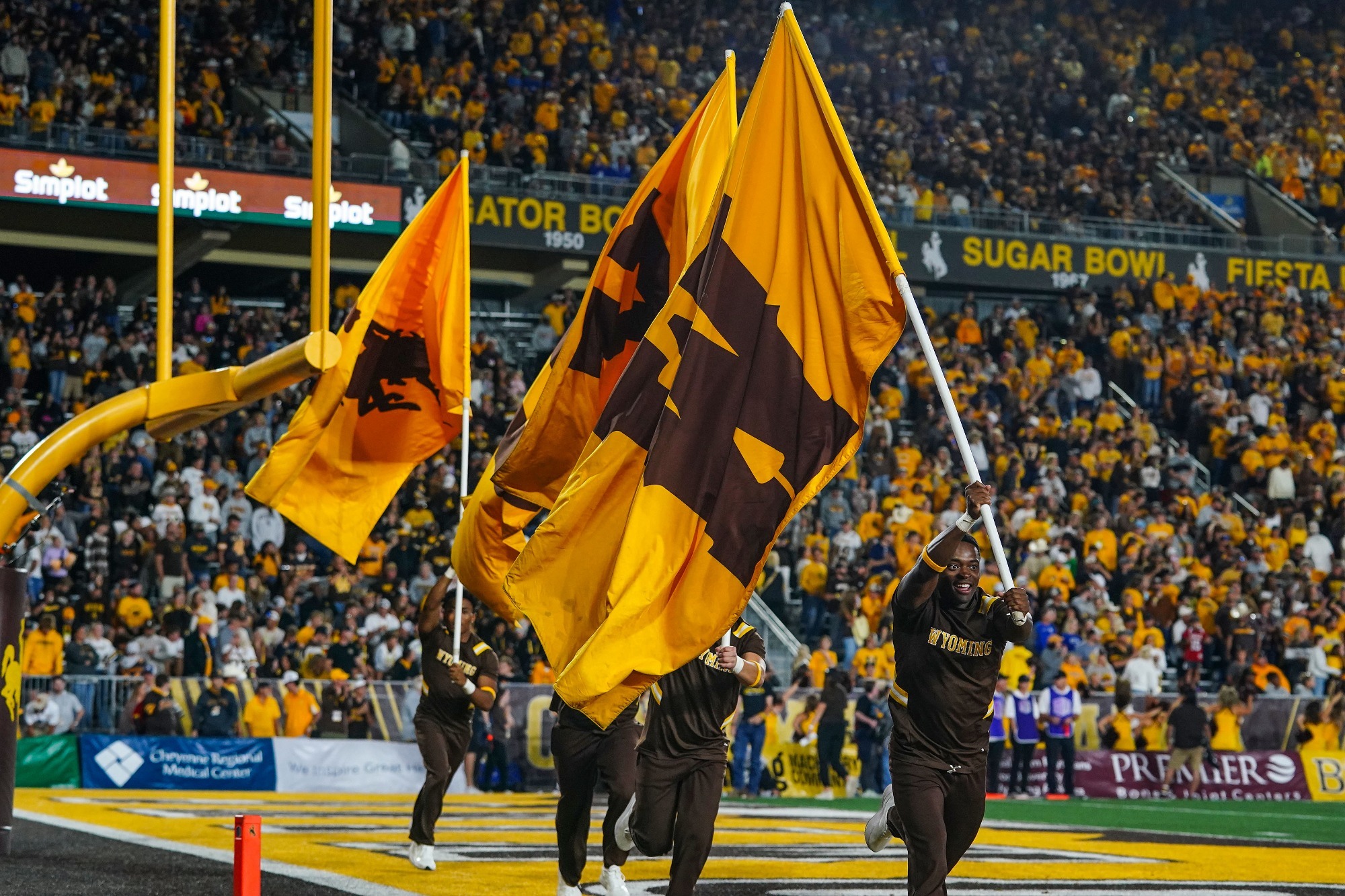 Sept 14; Laramie, WY, USA; Wyoming Cowboys cheer team with flags against the Brigham Young Cougars at Jonah Field at War Memorial Stadium. The Cowboys lost to the Cougars 34-14.  Mandatory Credit: Troy Babbitt-UW Media-Athletics