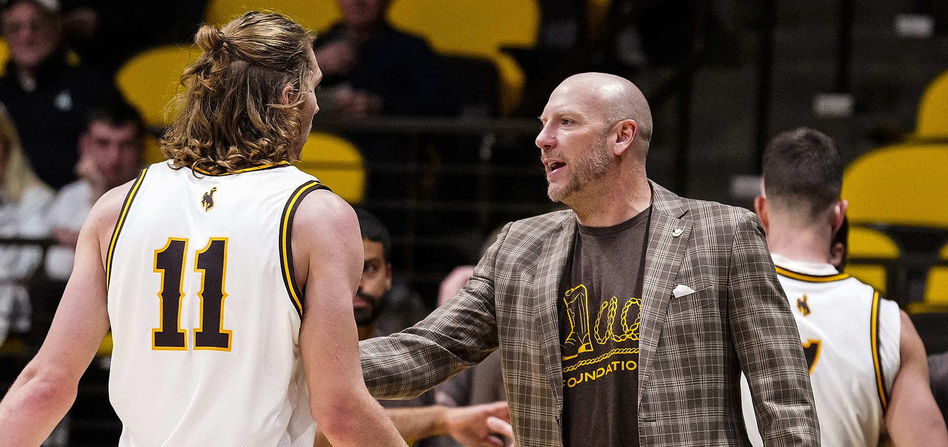 Wyoming head coach Sundance Wicks and forward Gavin Gores.