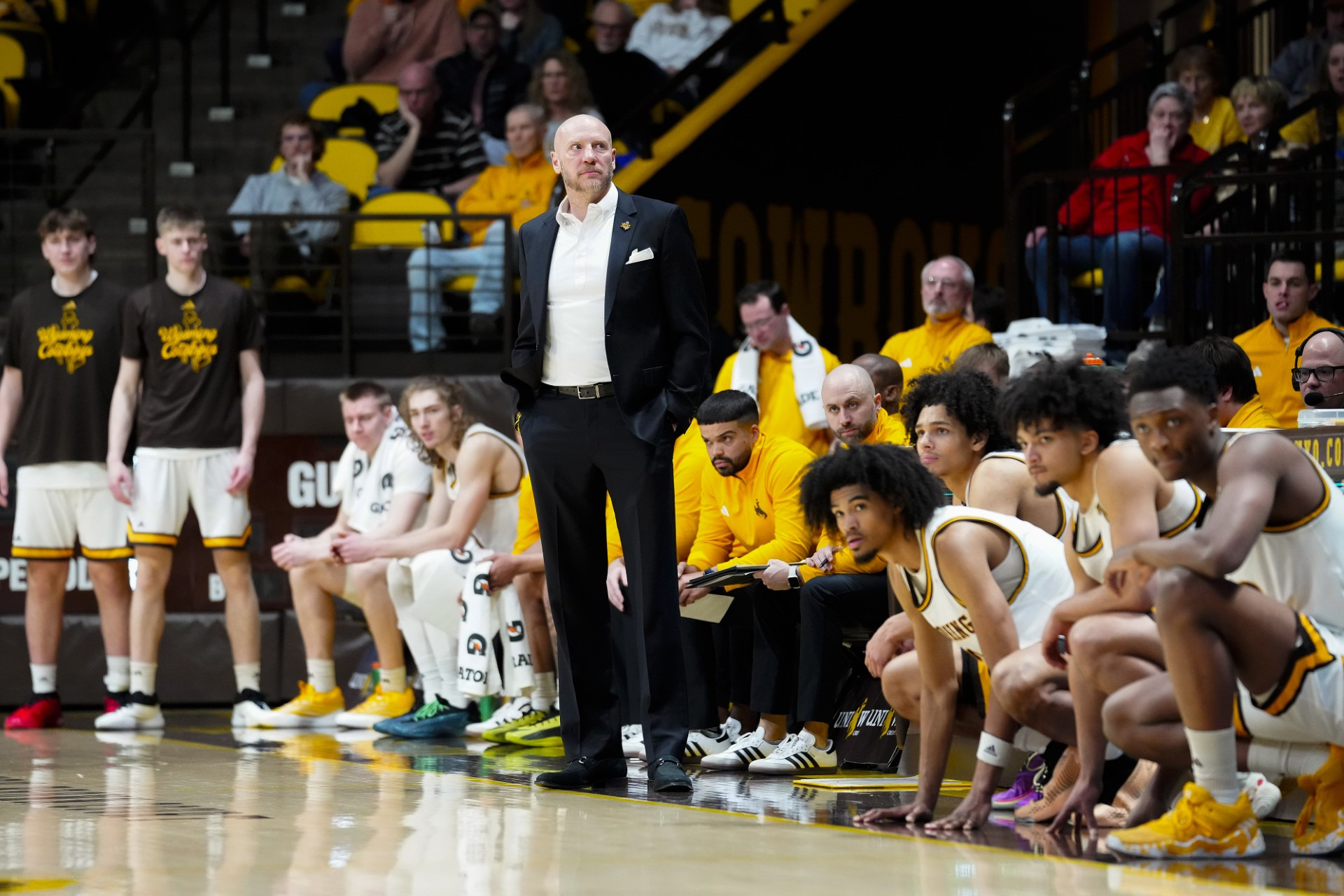 Wyoming head coach Sundance Wicks and the Cowboy bench versus Grand Canyon.