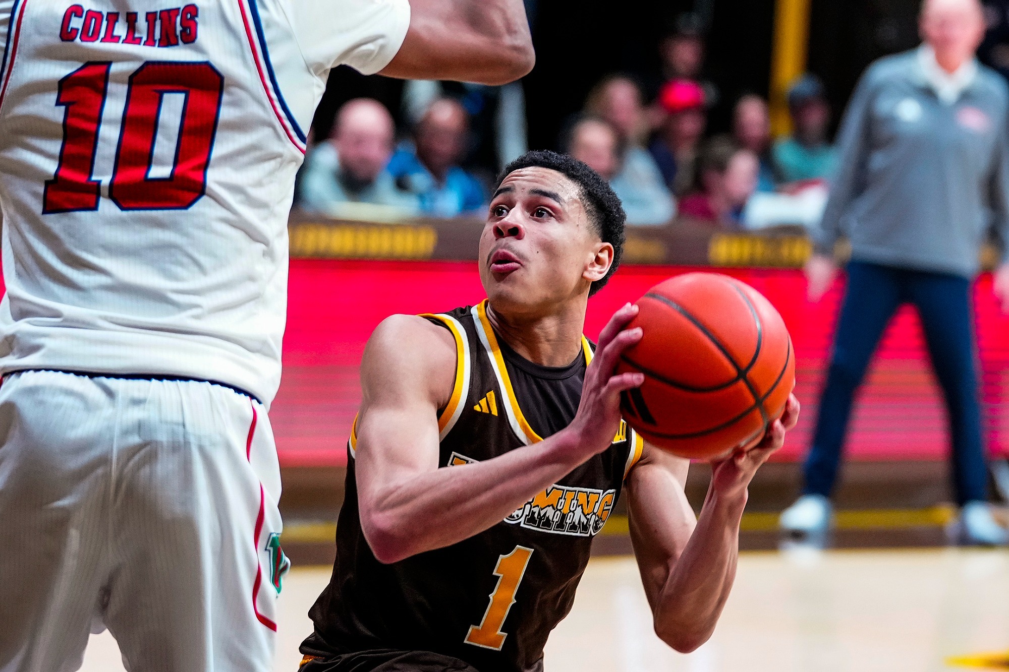 Damarion Dennis drive to the hoop against Fresno State in 2026
