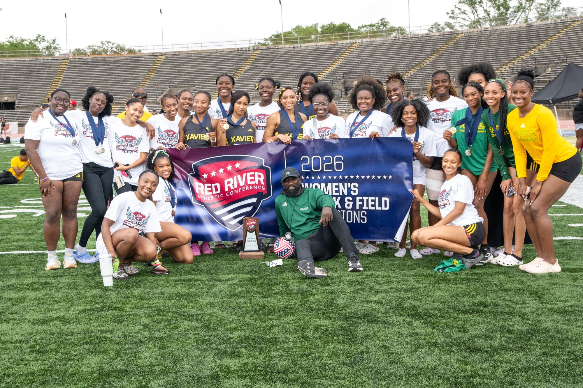 Women's Track and Field with 2026 RRAC championship banner