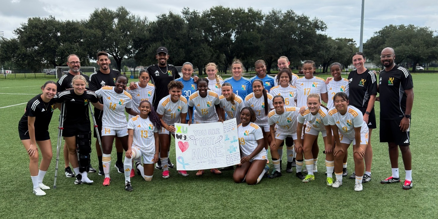Men's and Women's Soccer Players with Poster