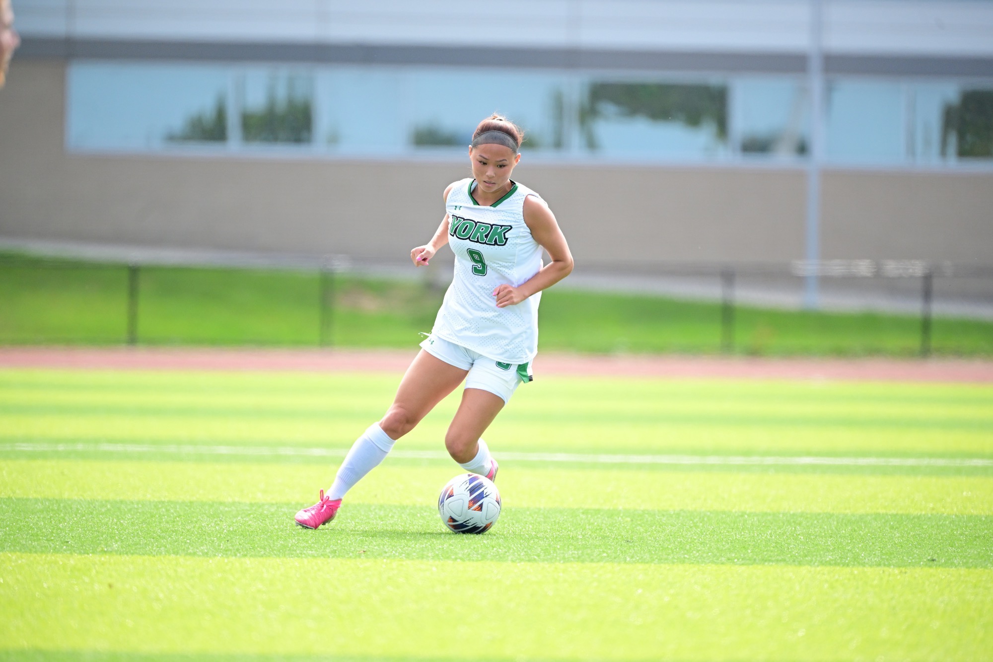 Female dribbling soccer ball