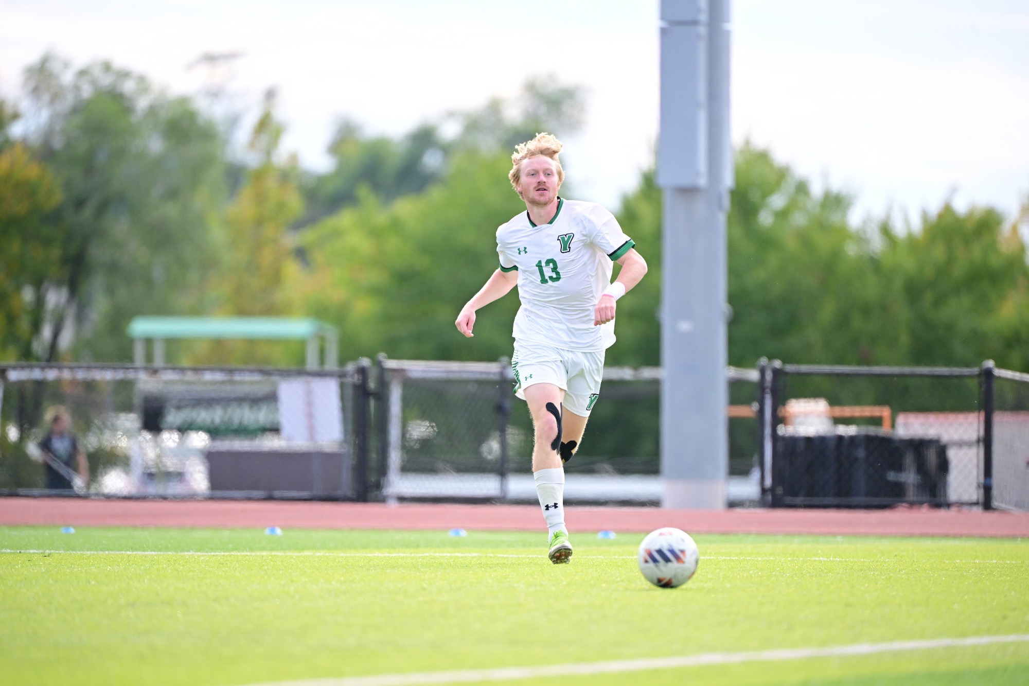 Male running after soccer ball