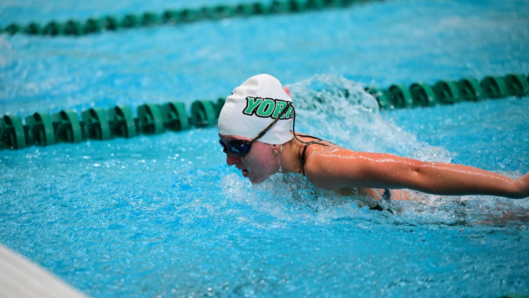 female swimmer competes in butterfly