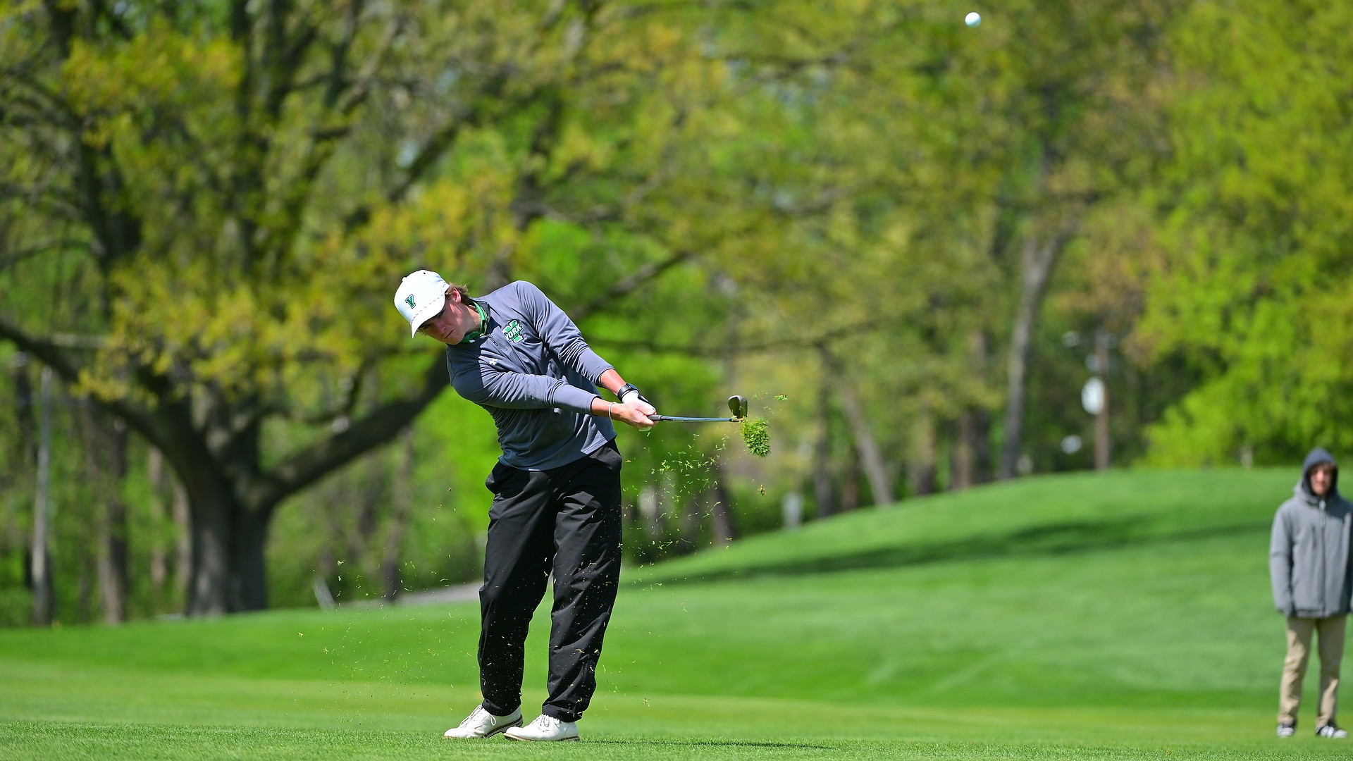 male golfer hits tee shot