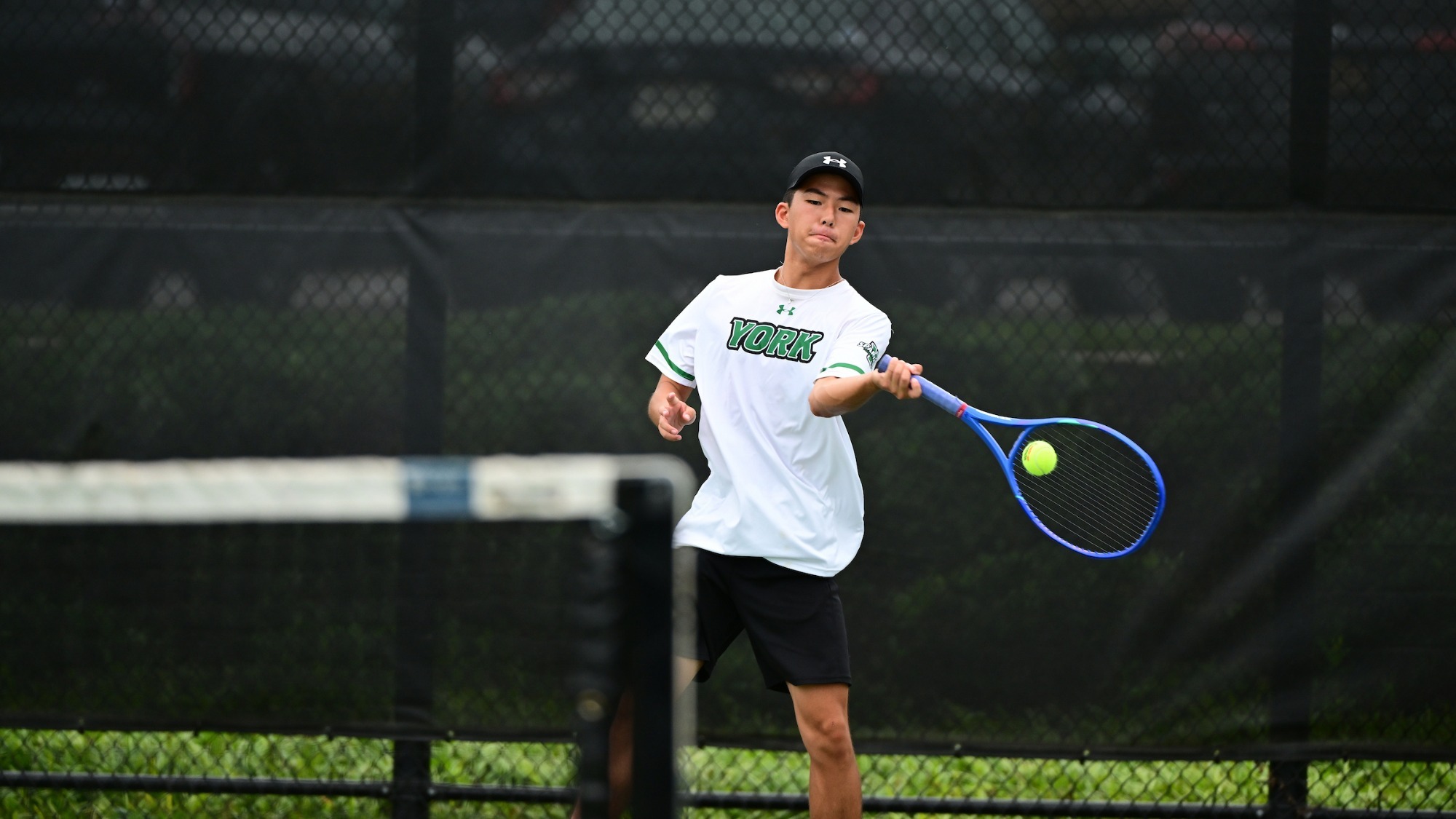 male tennis player strikes a forehand