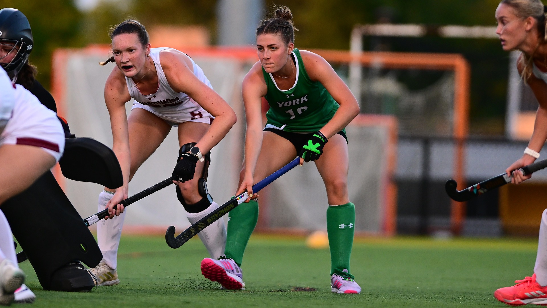 female field hockey player stares down opponent