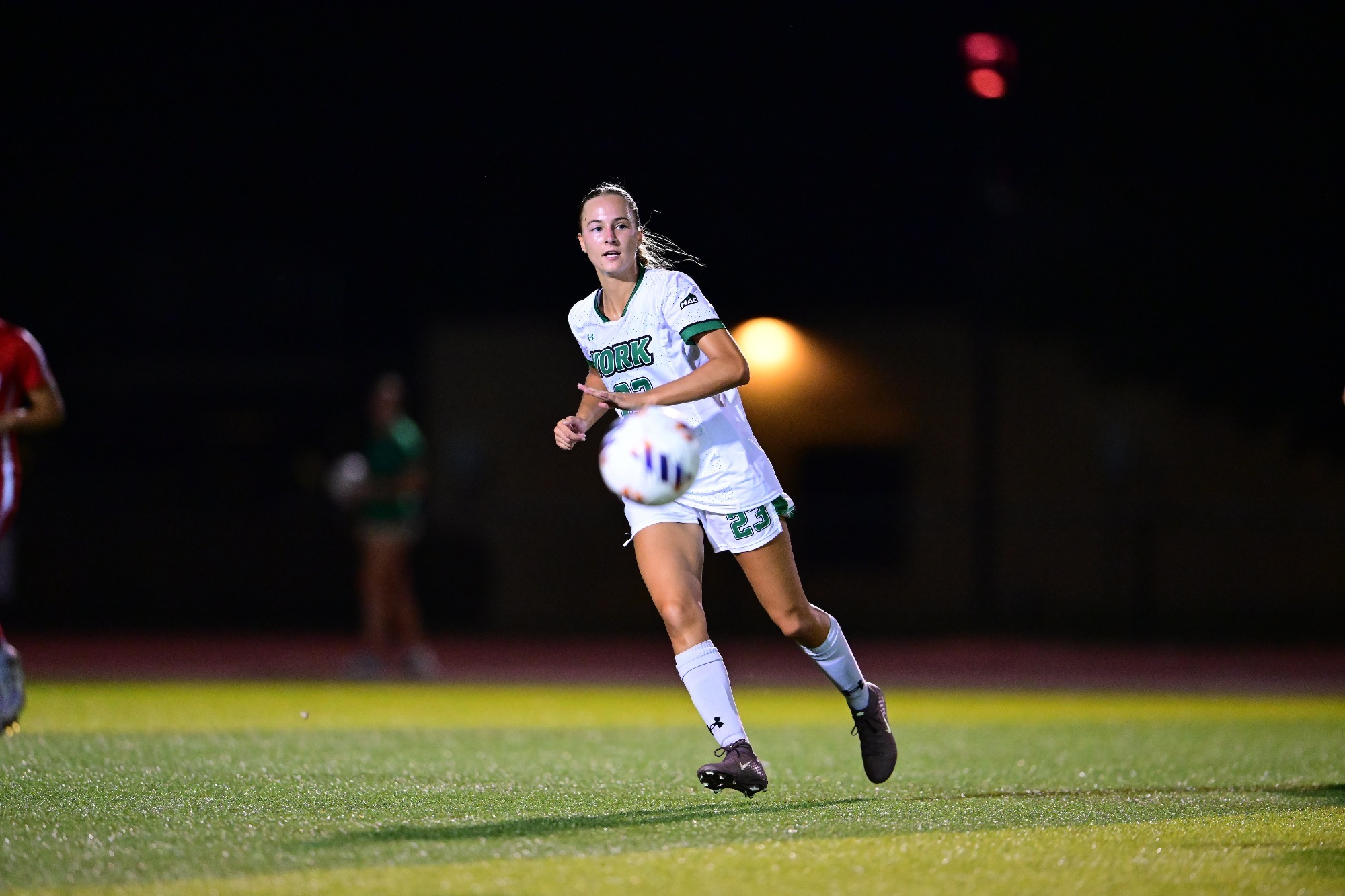 Female running after soccer ball