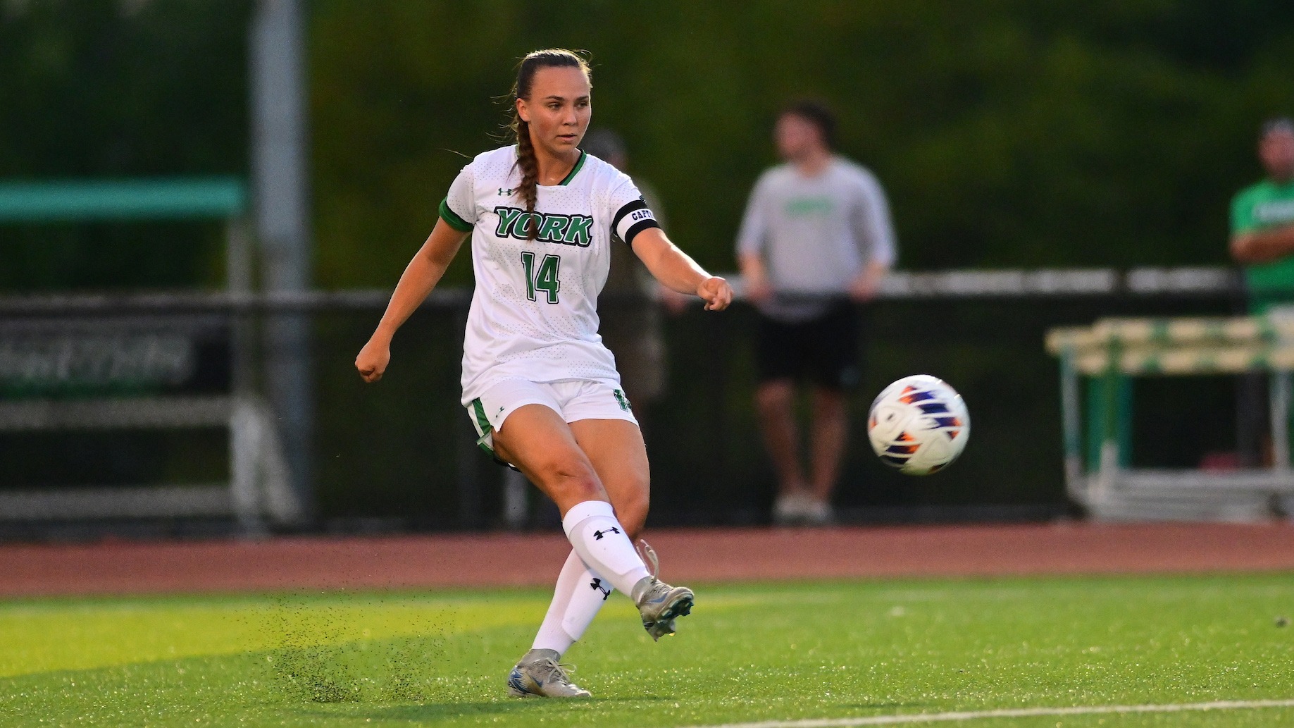 female soccer player serves a pass into the box