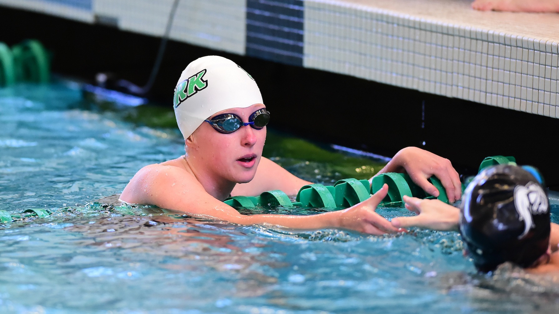female swimmer congratulates competitor after event