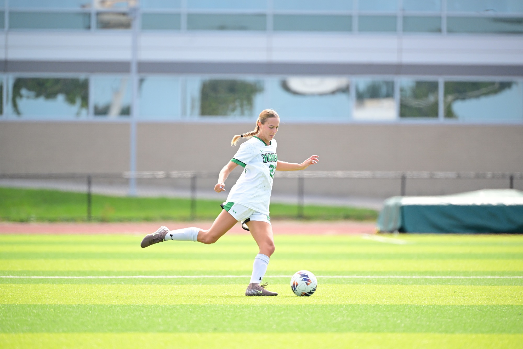 Female kicking soccer ball