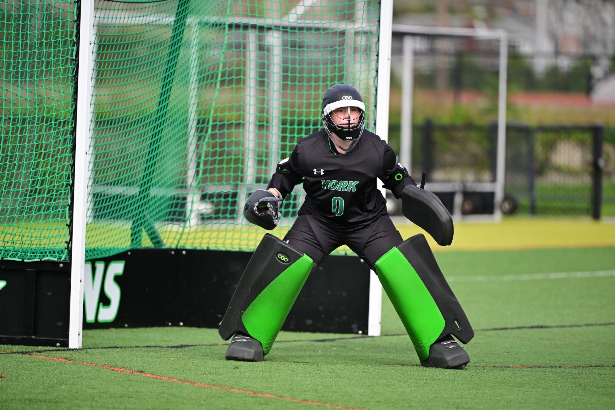 Female in field hockey goalie equipment