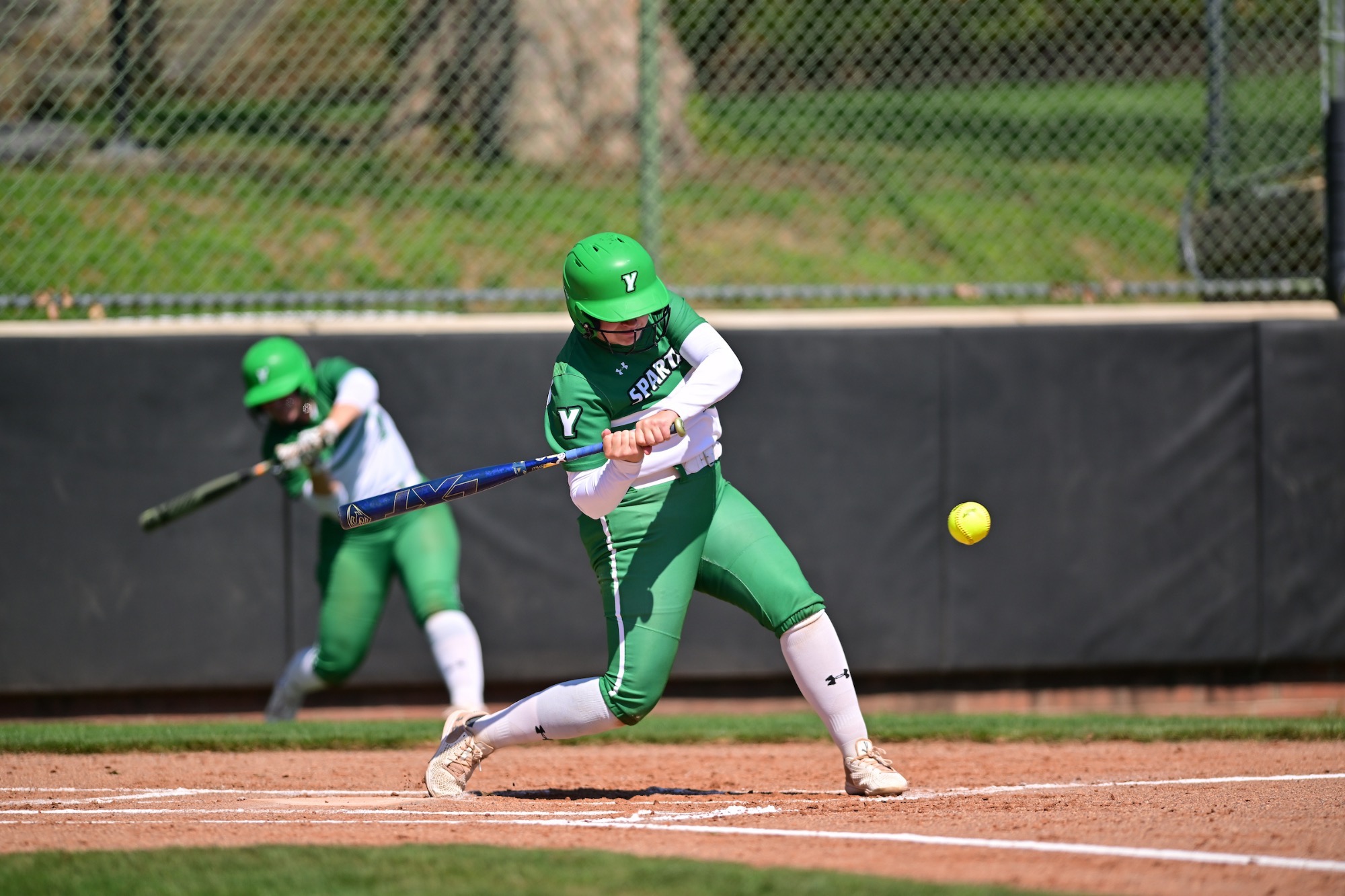 Softball player hitting a softball