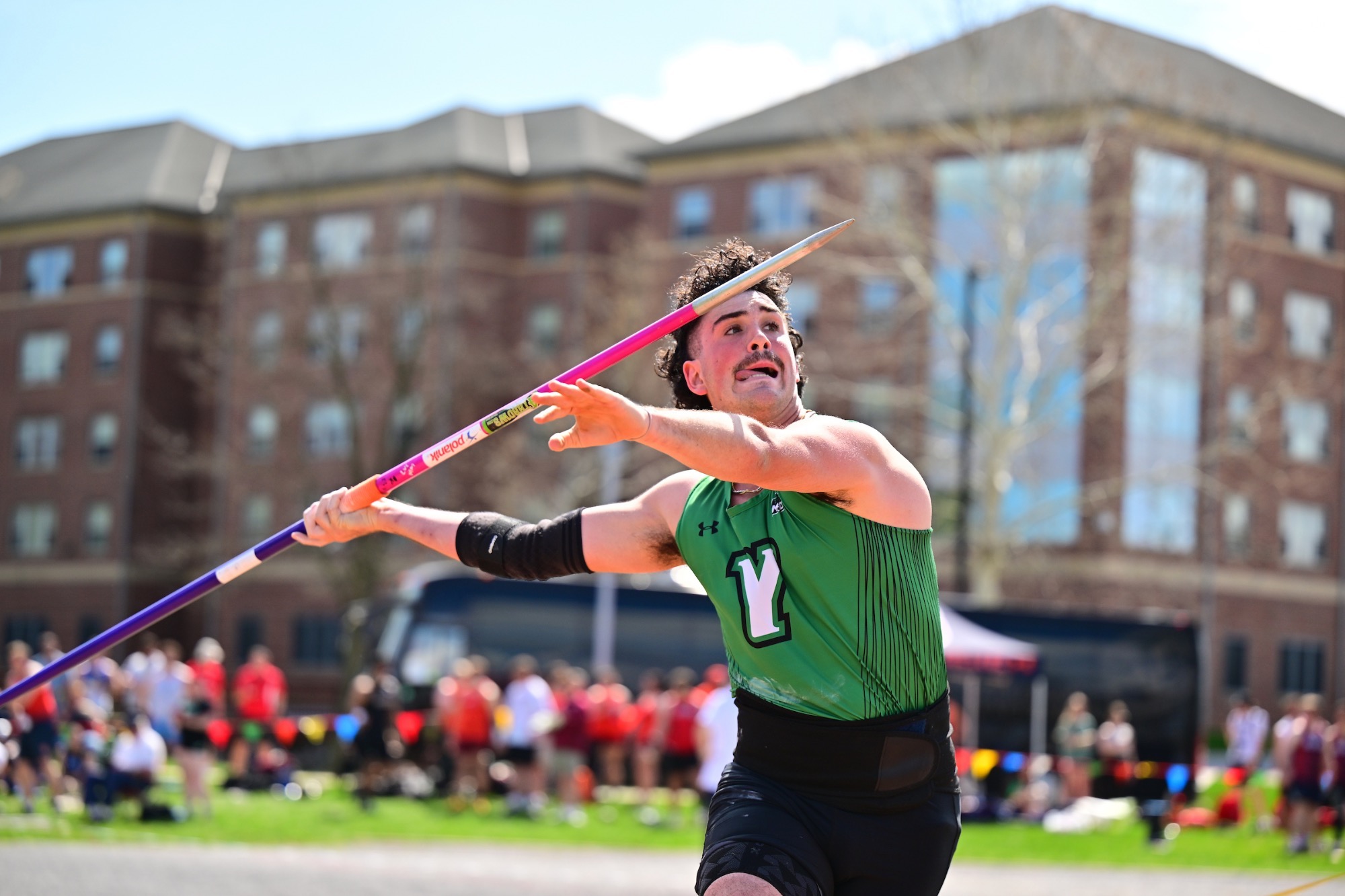 Male student athlete throwing a javelin 