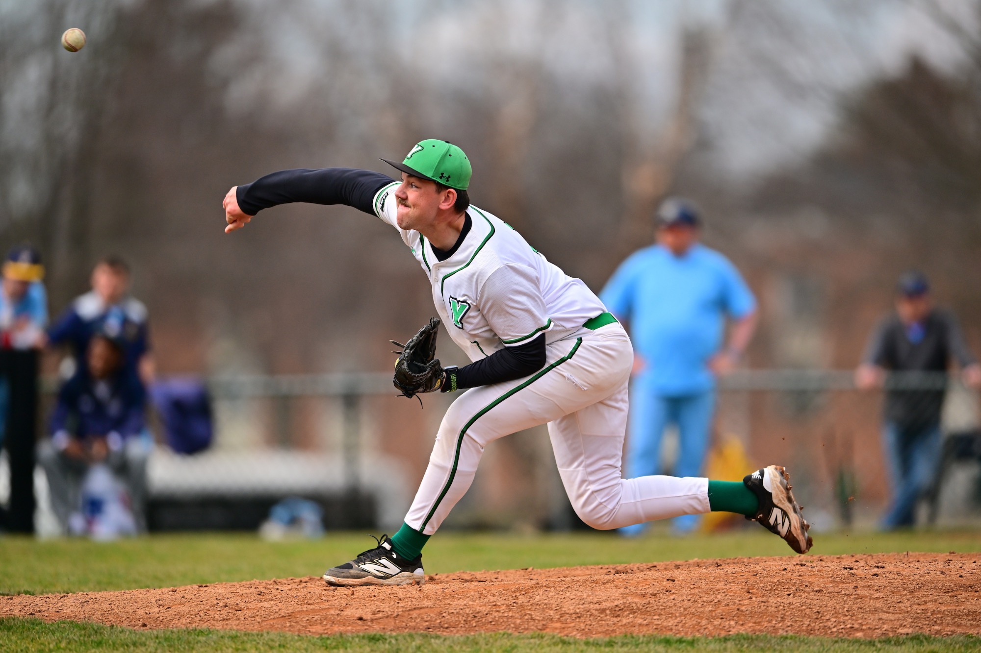 male in white uniform pitching baseball