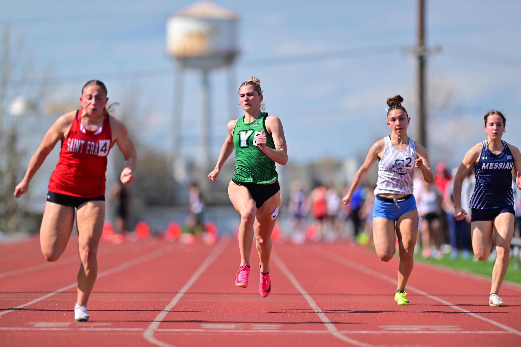 female in green uniform running