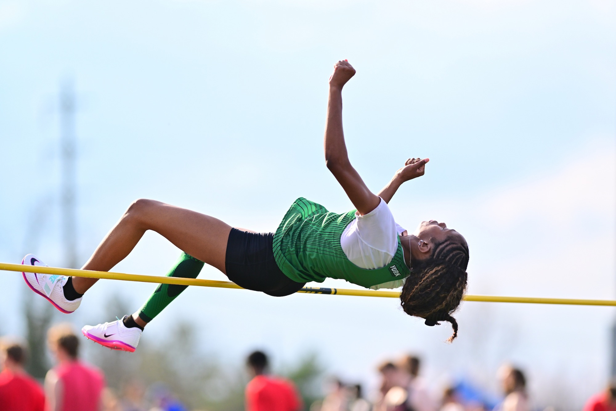 Female jumping over pole