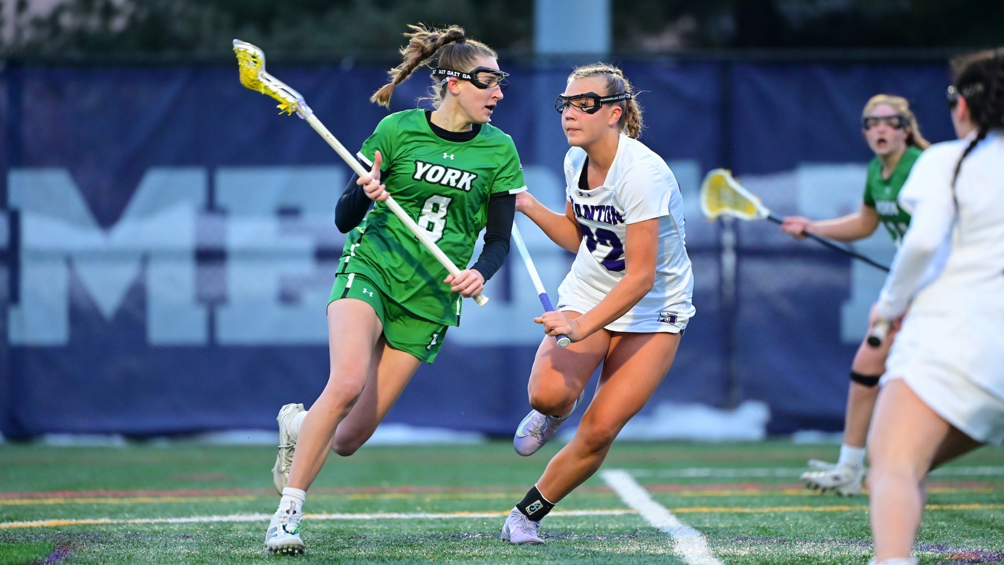 women's lacrosse player in green uniform