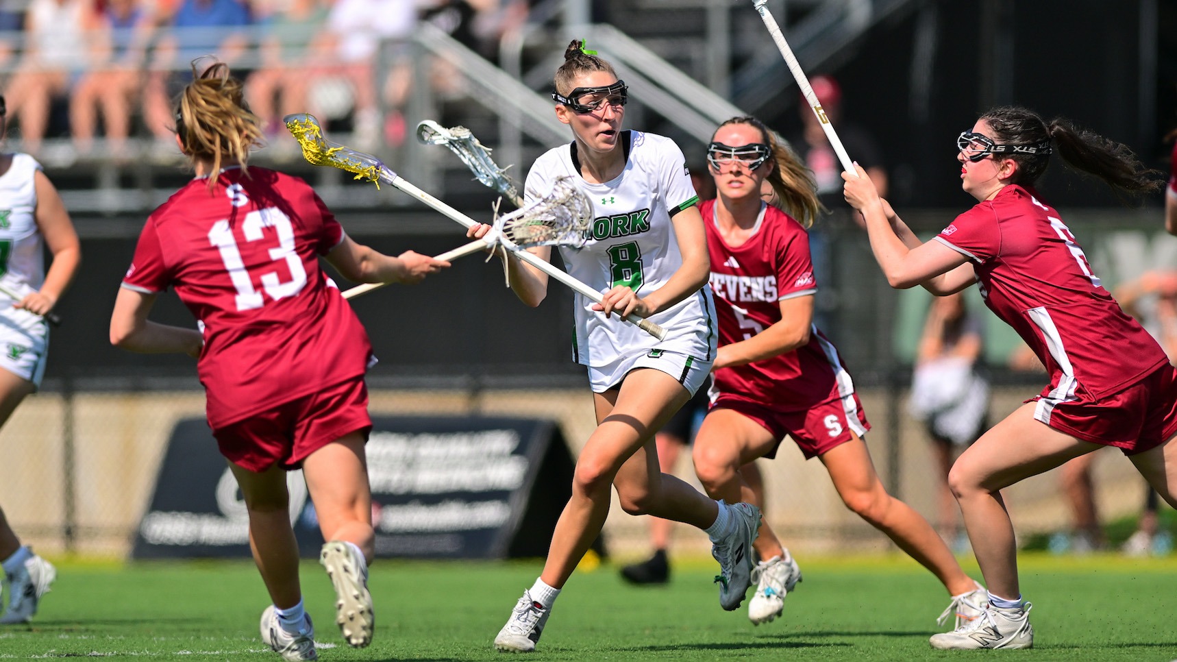 female lacrosse player moves through defenders
