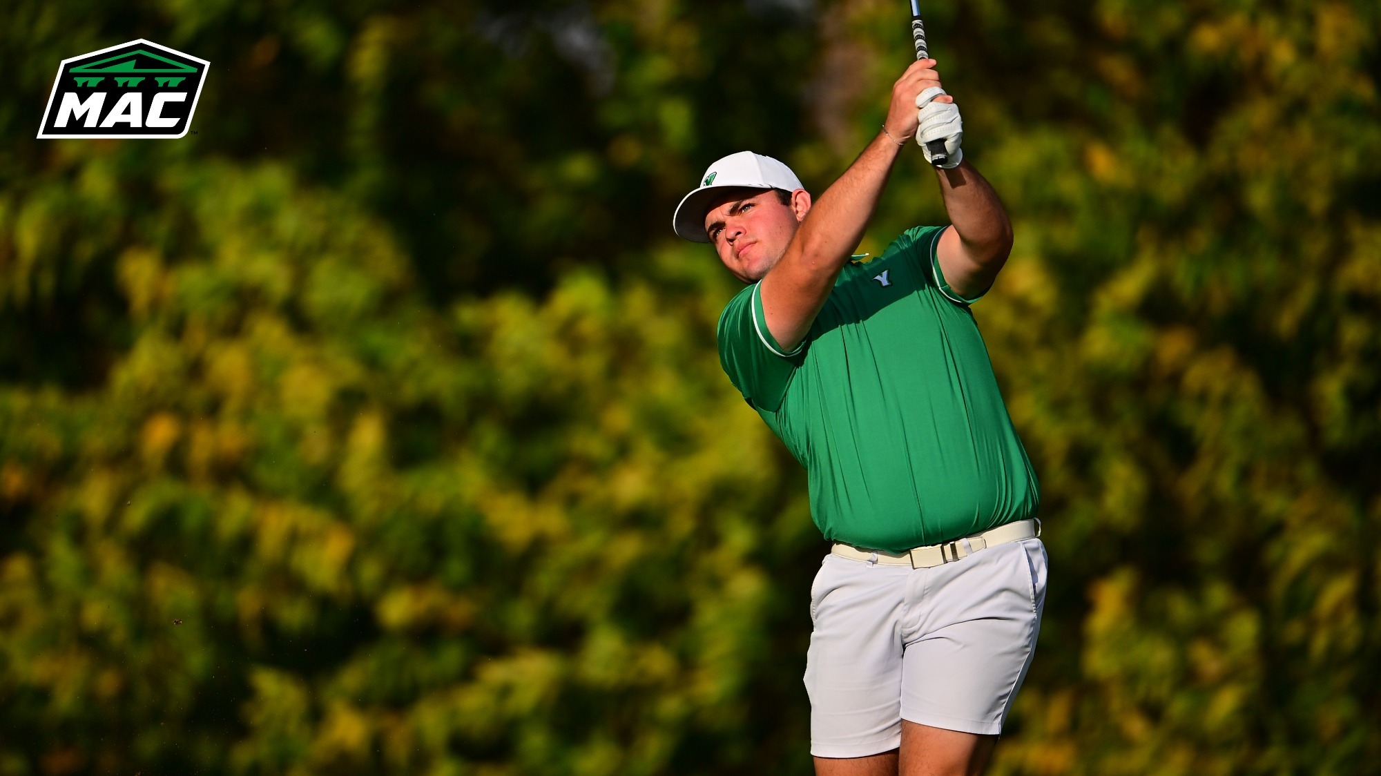 male golfer stares down a tee shot with a MAC logo in upper left corner