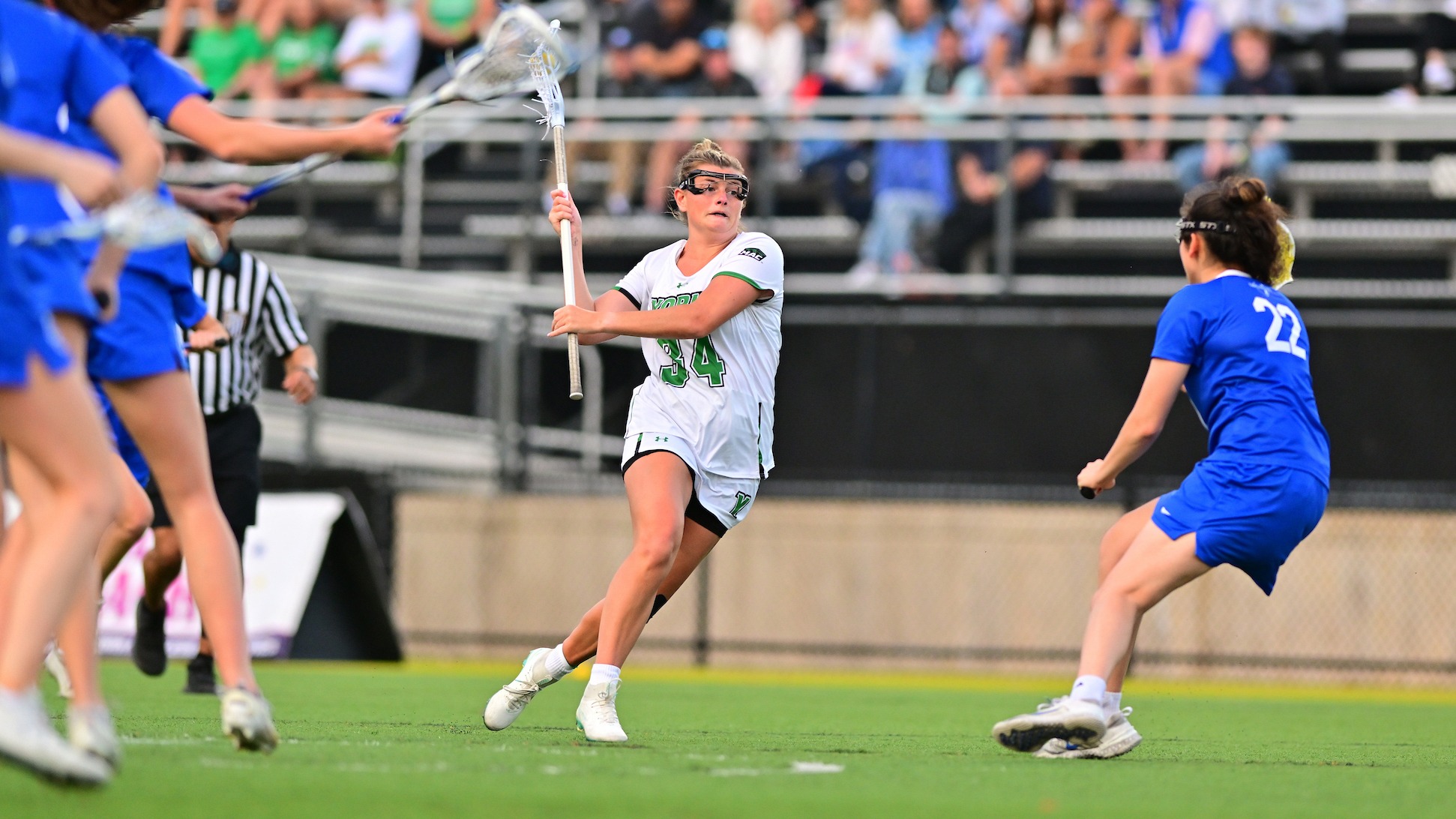 female lacrosse player dodges defender