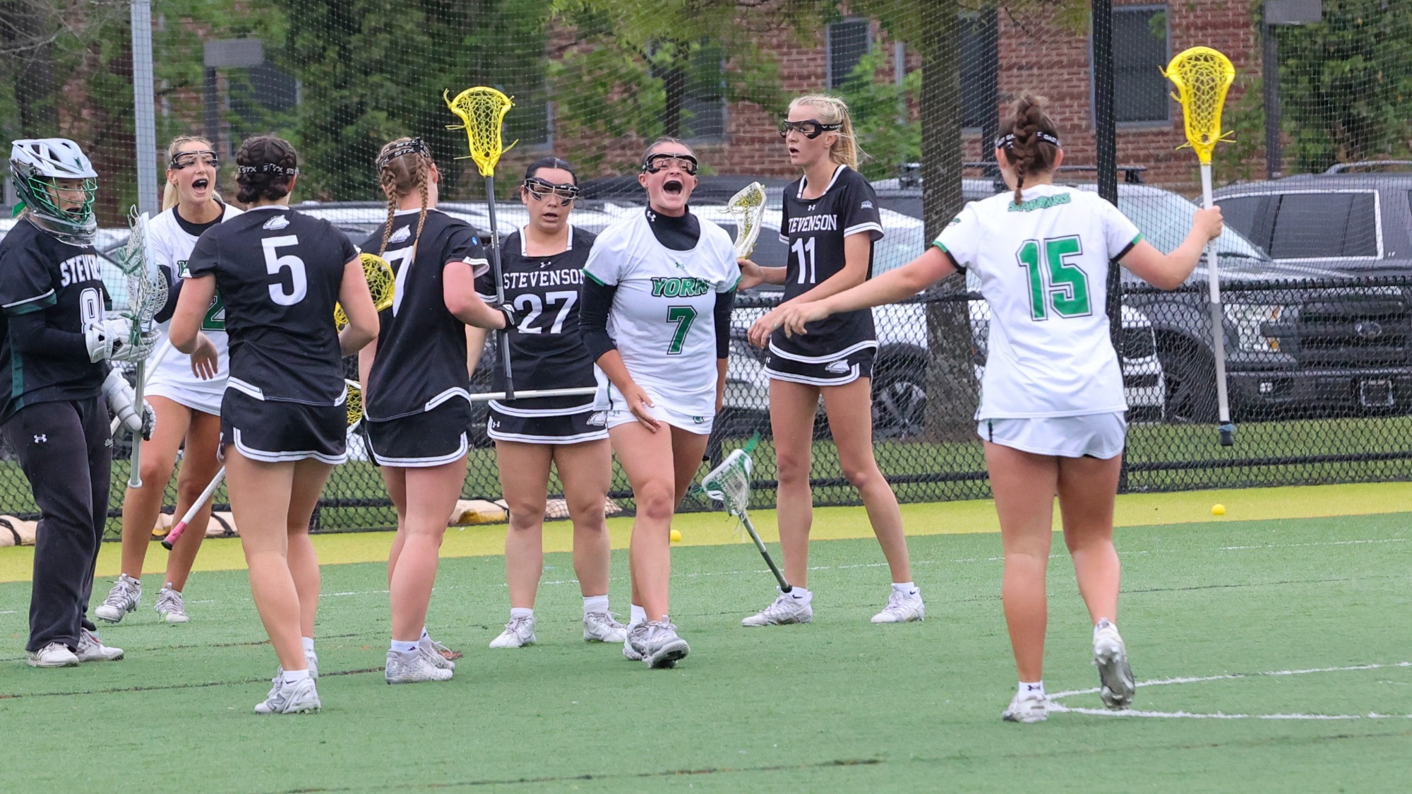 female women's lacrosse player celebrates after a goal