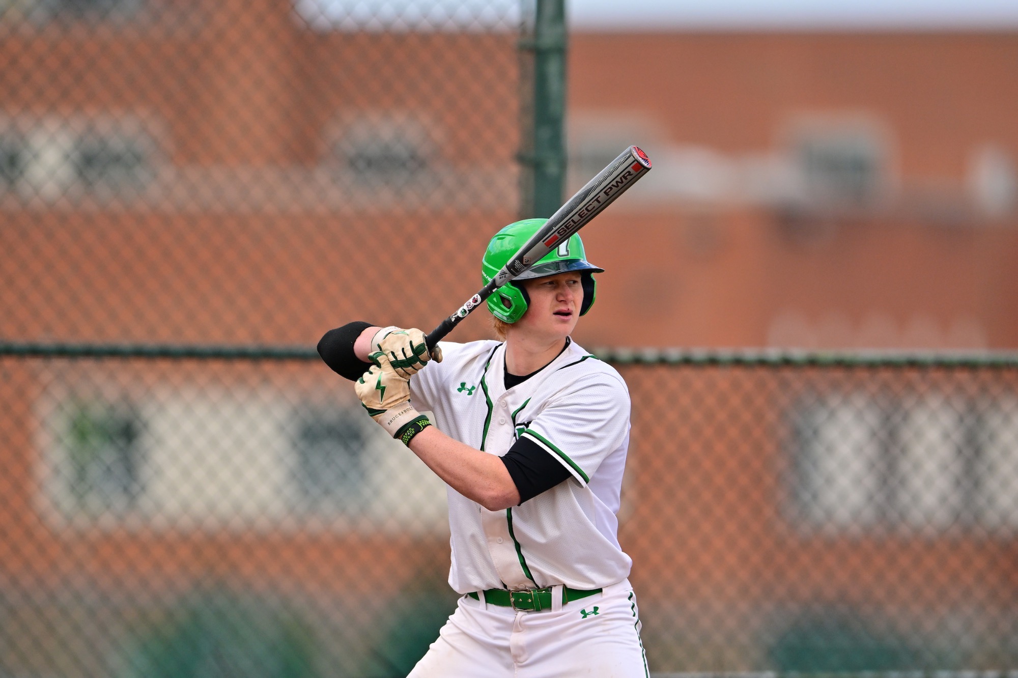 Baseball batter in white uniform in batting box
