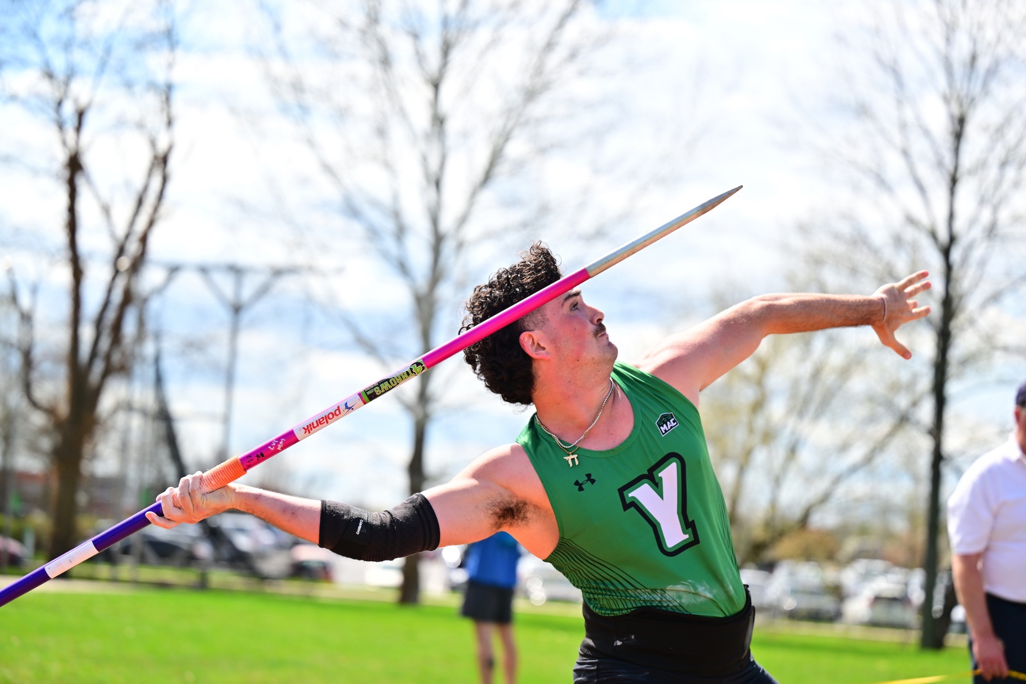 Male in green throwing javelin