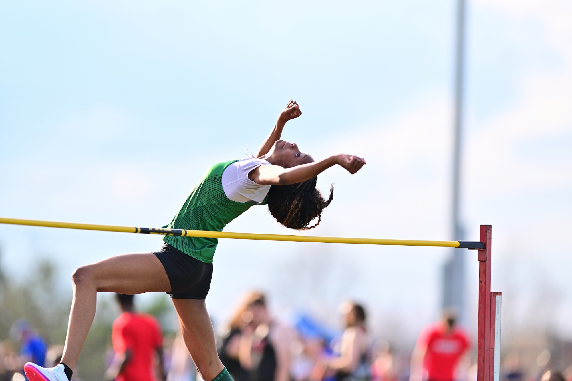 Female competing in high jump