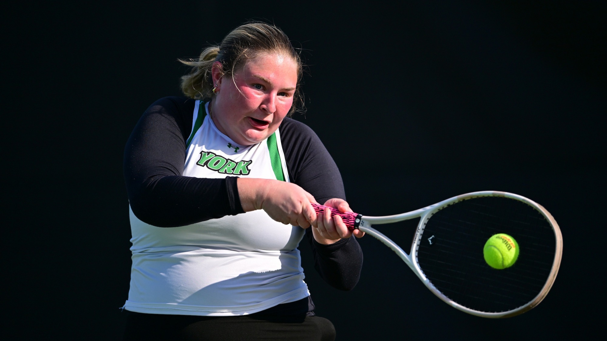 female tennis player returns serve