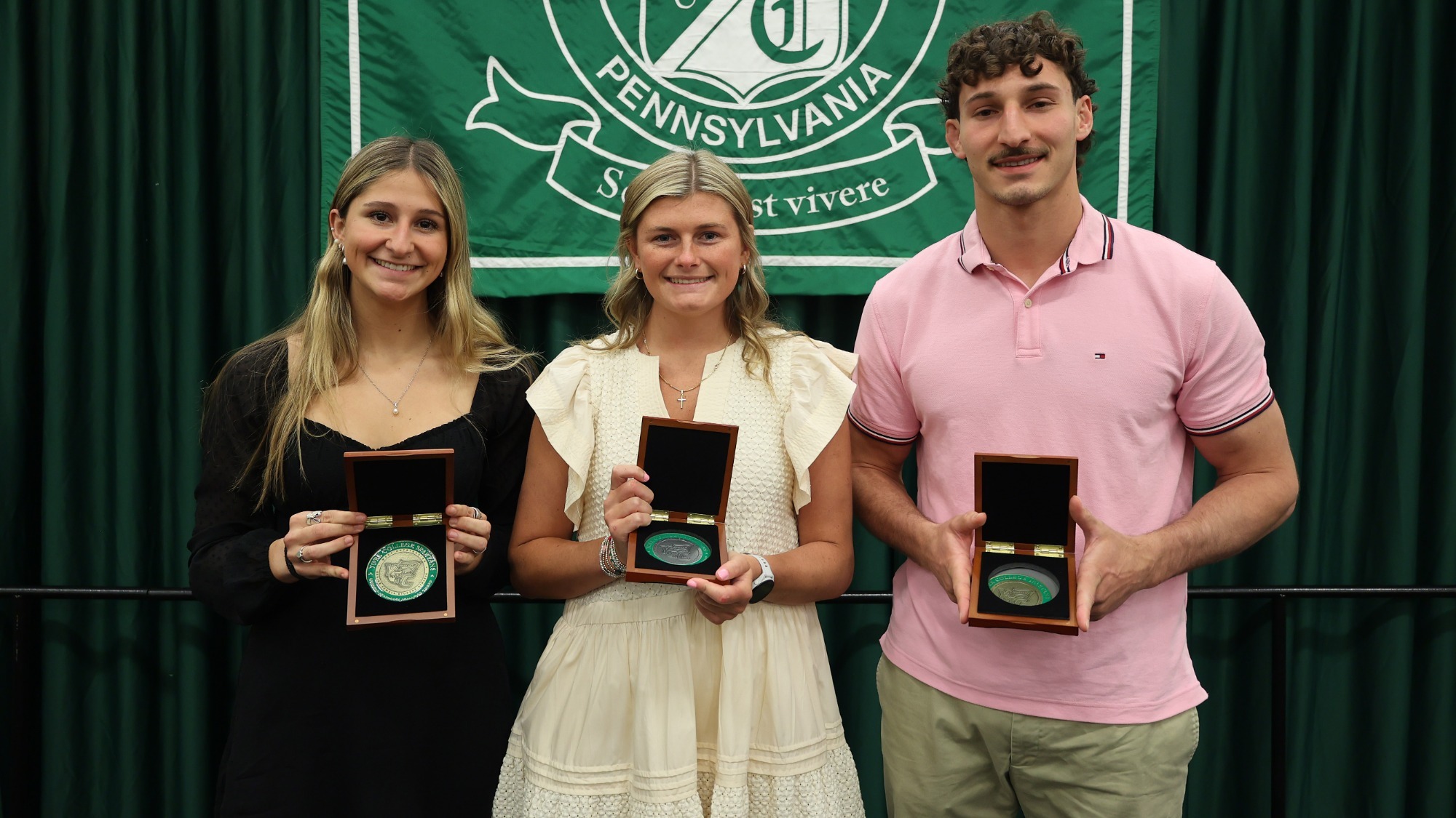 senior student-athletes pose for a picture with their department award