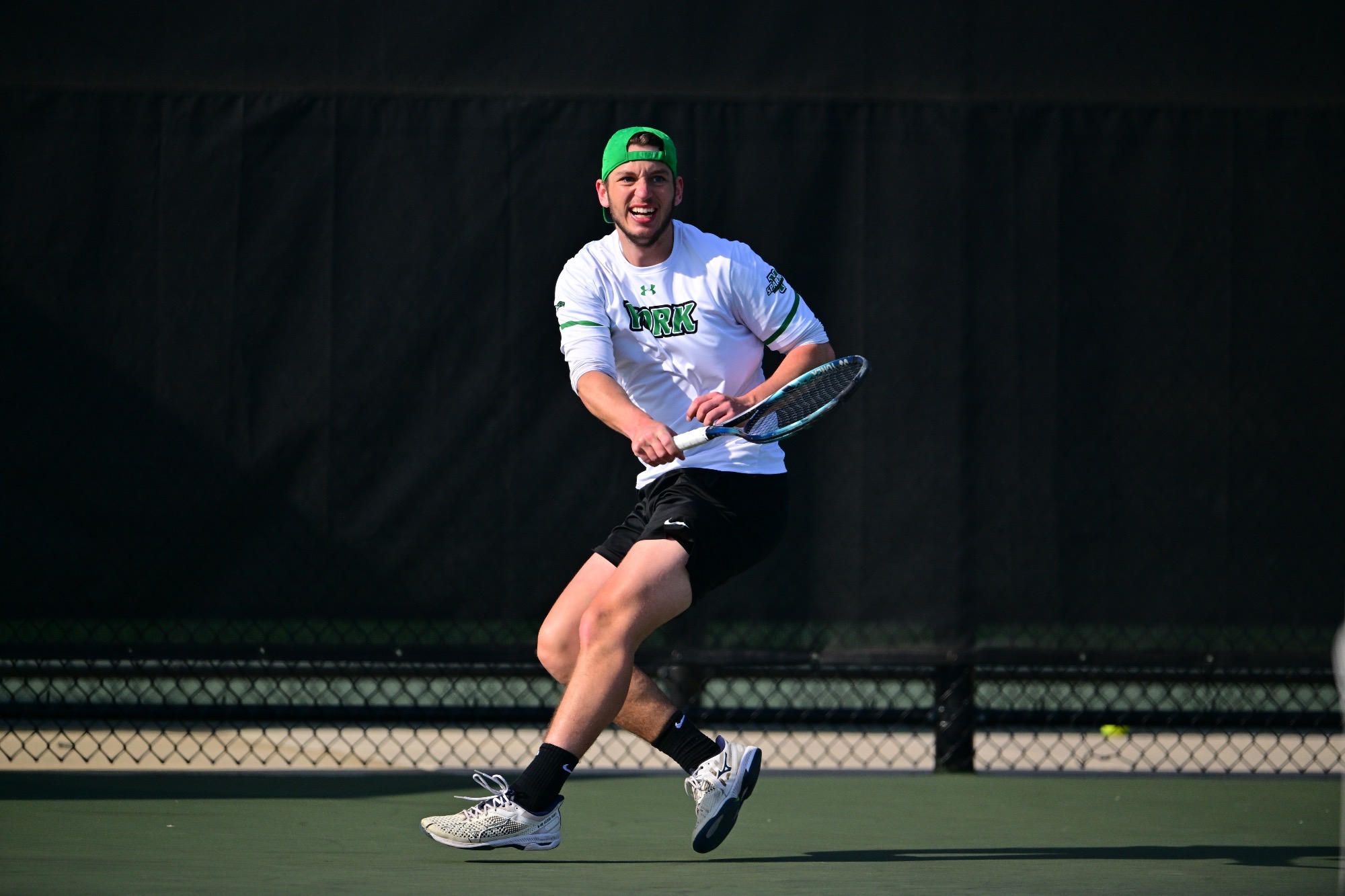 male holding tennis racket