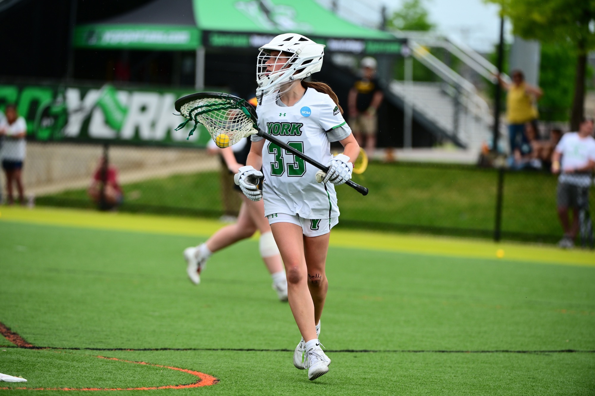 female with lacrosse stick in hand