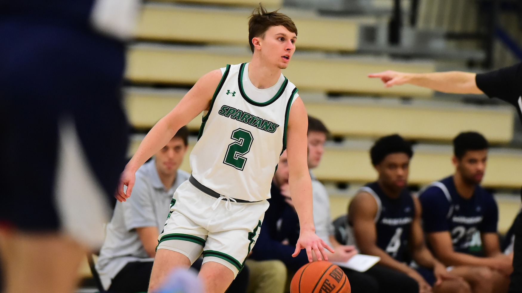 male basketball player dribbles down the floor