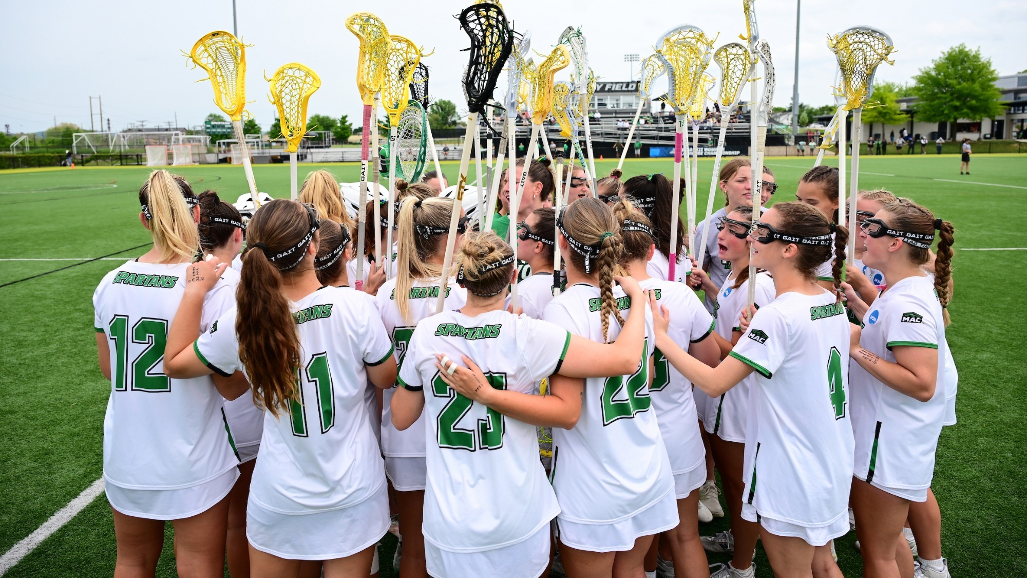 female lacrosse players huddle up pregame