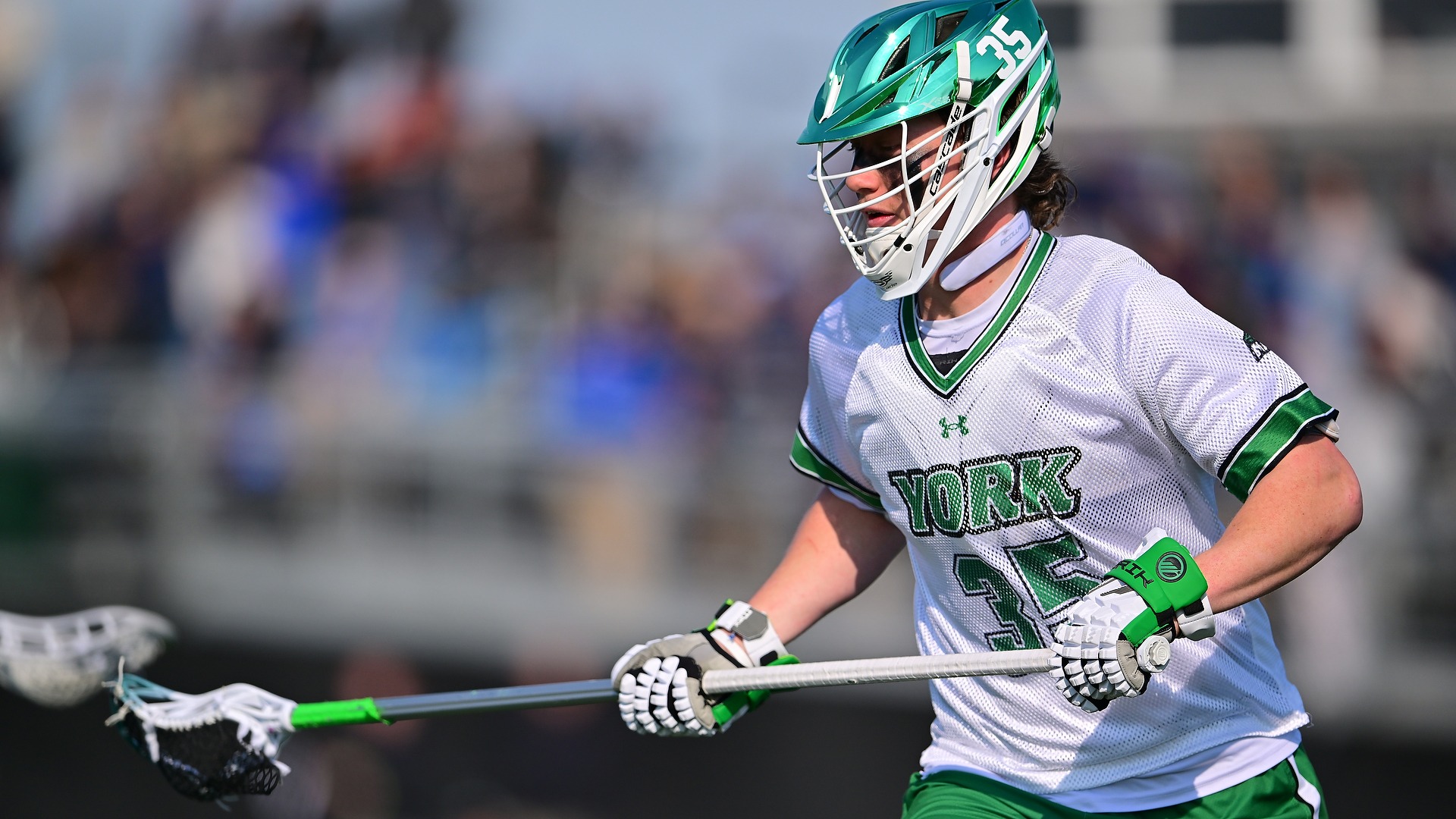 male lacrosse player defends opponent