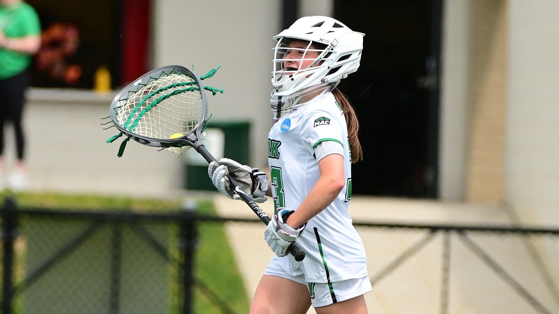 female lacrosse goalie looks to pass