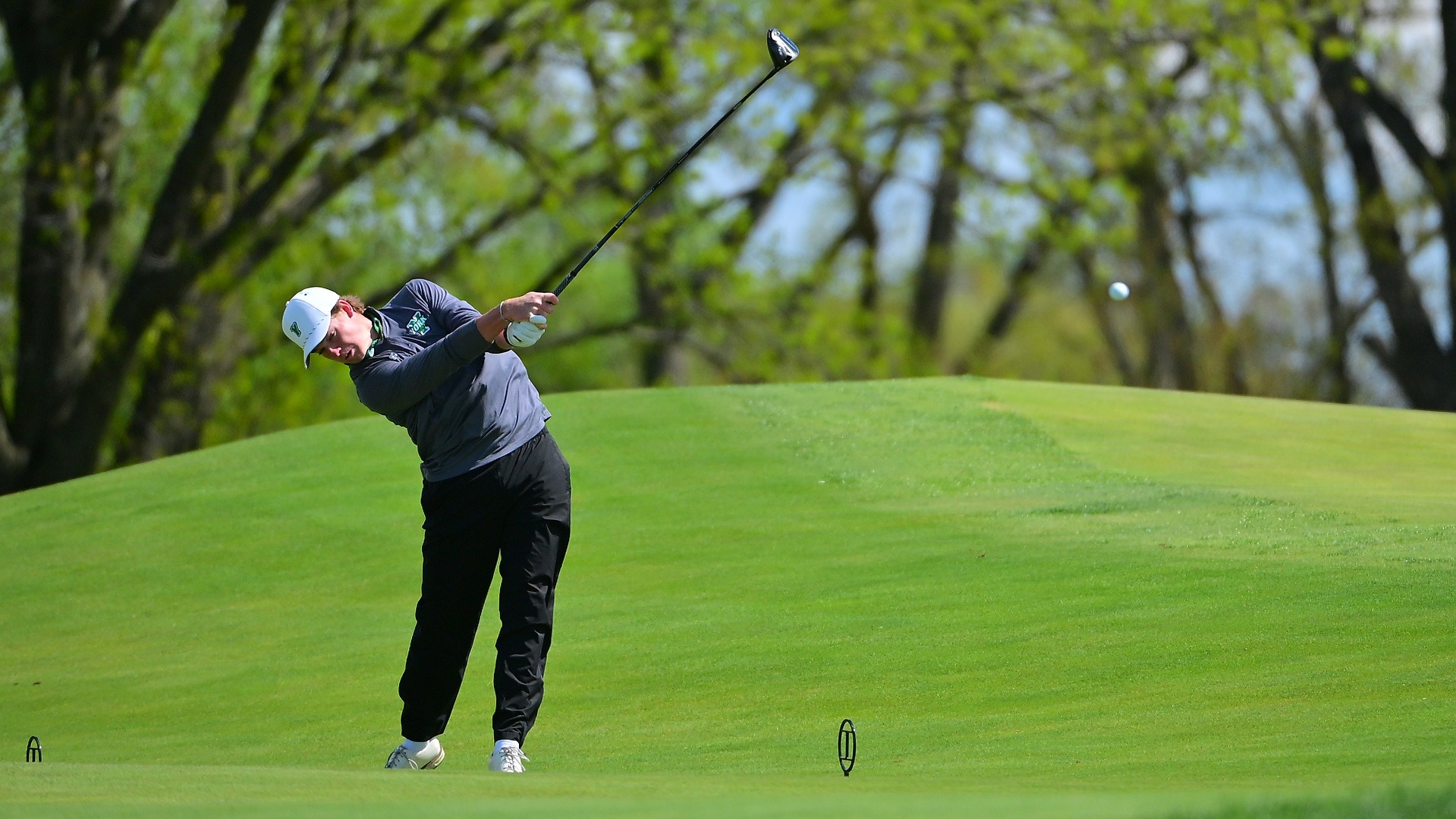 male golfer hits driver off the tee