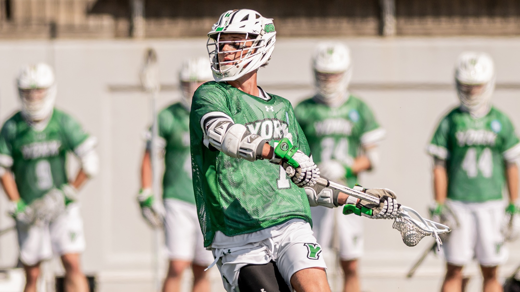 male lacrosse player loads up for a shot