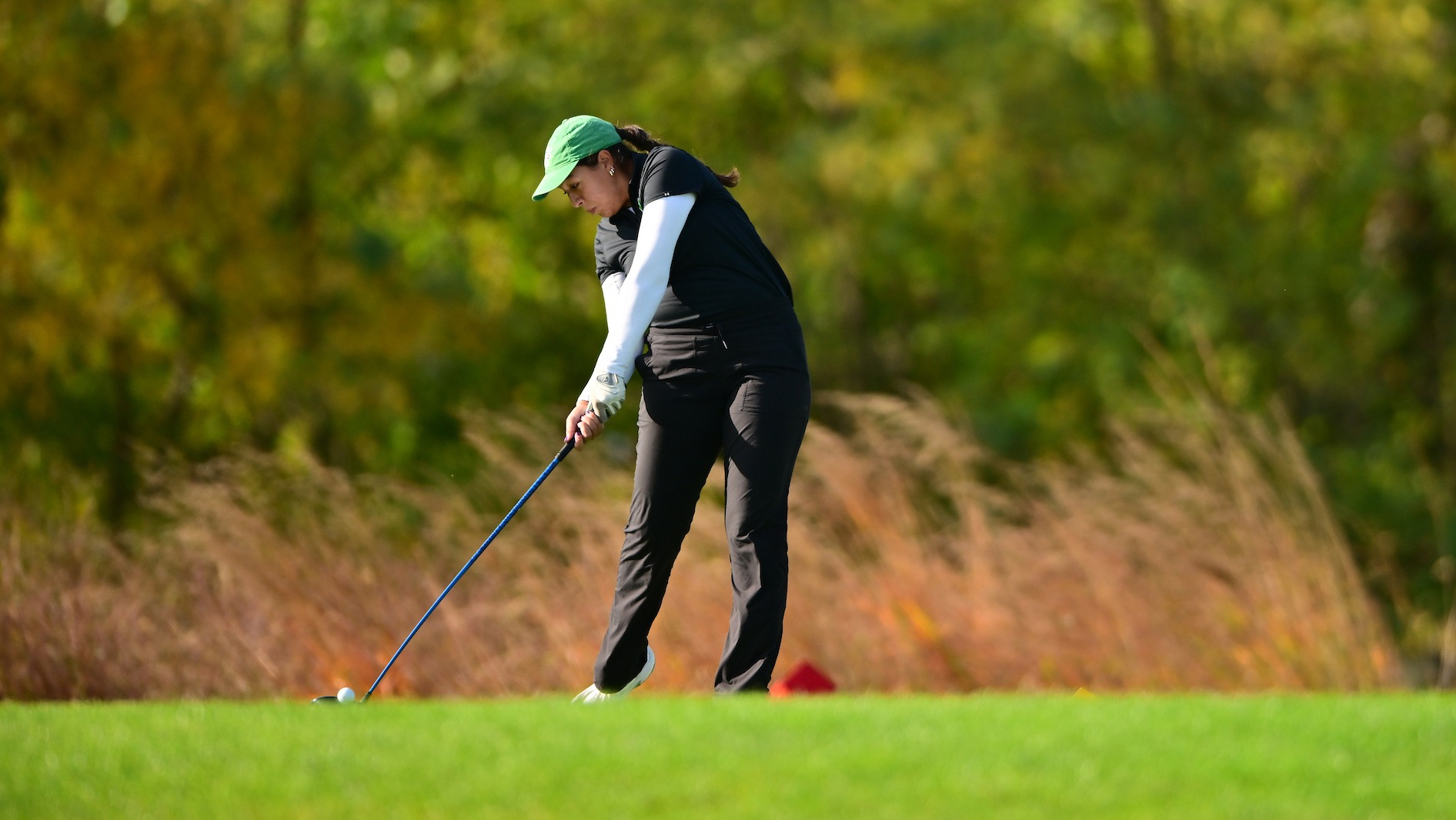 female golfer hits a tee shot at Royal Manchester