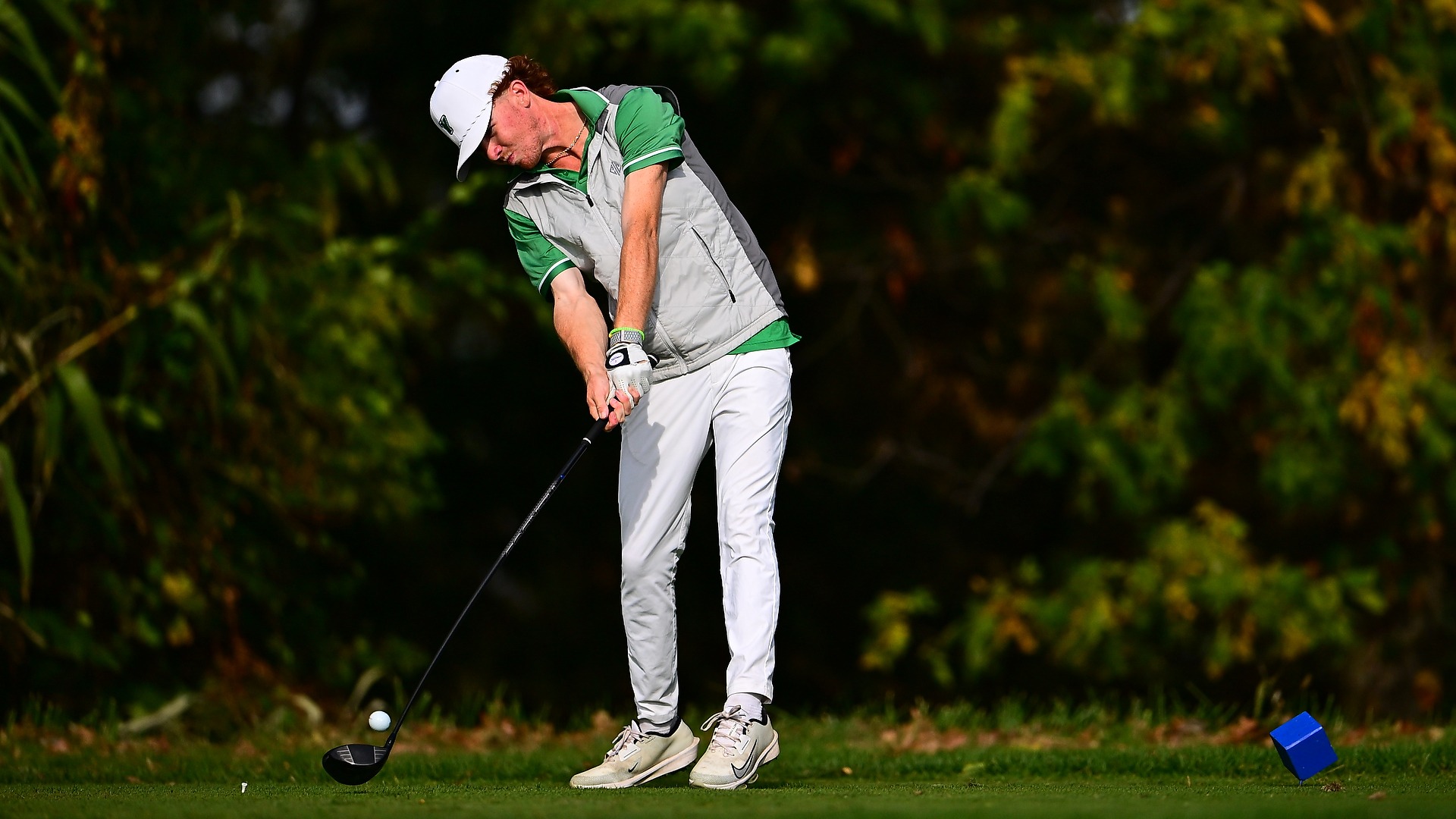 male golfer hits a tee shot at Royal Manchester Golf Links