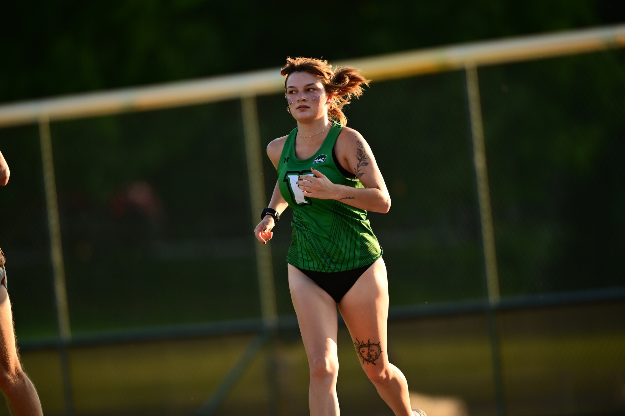 female running in green uniform