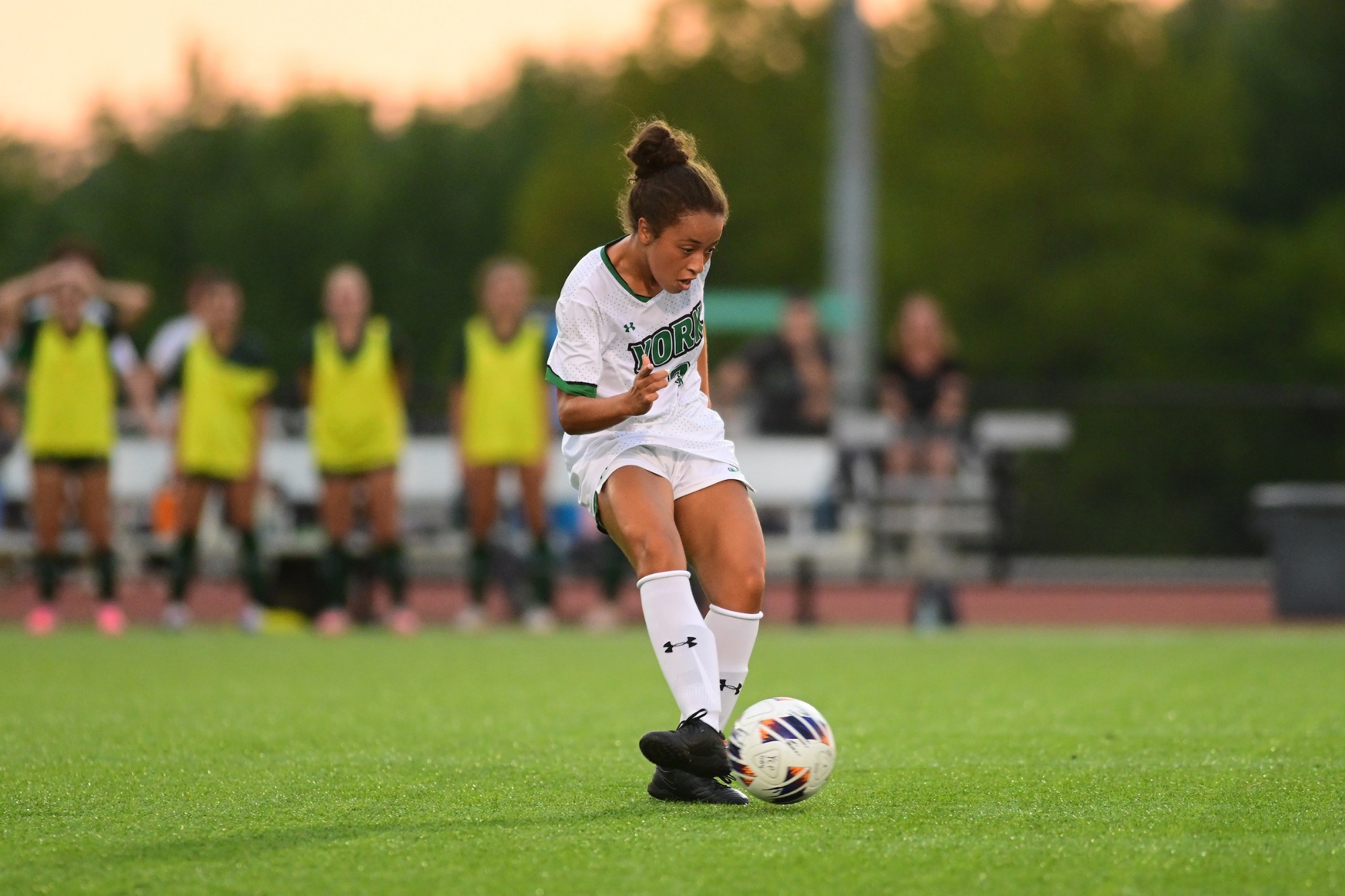 Female kicking soccer ball