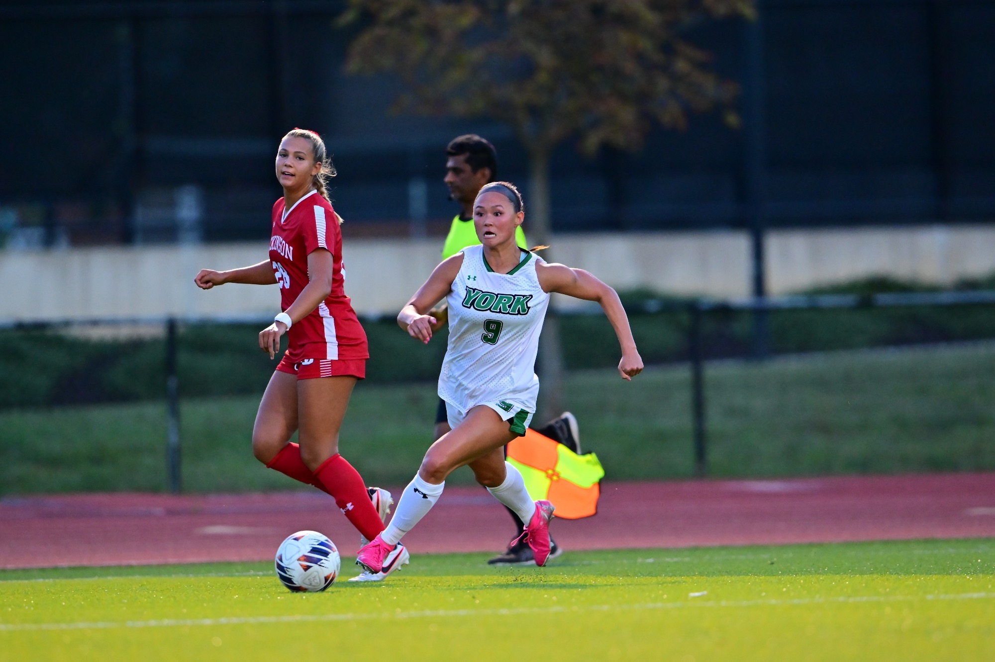female running after soccer ball