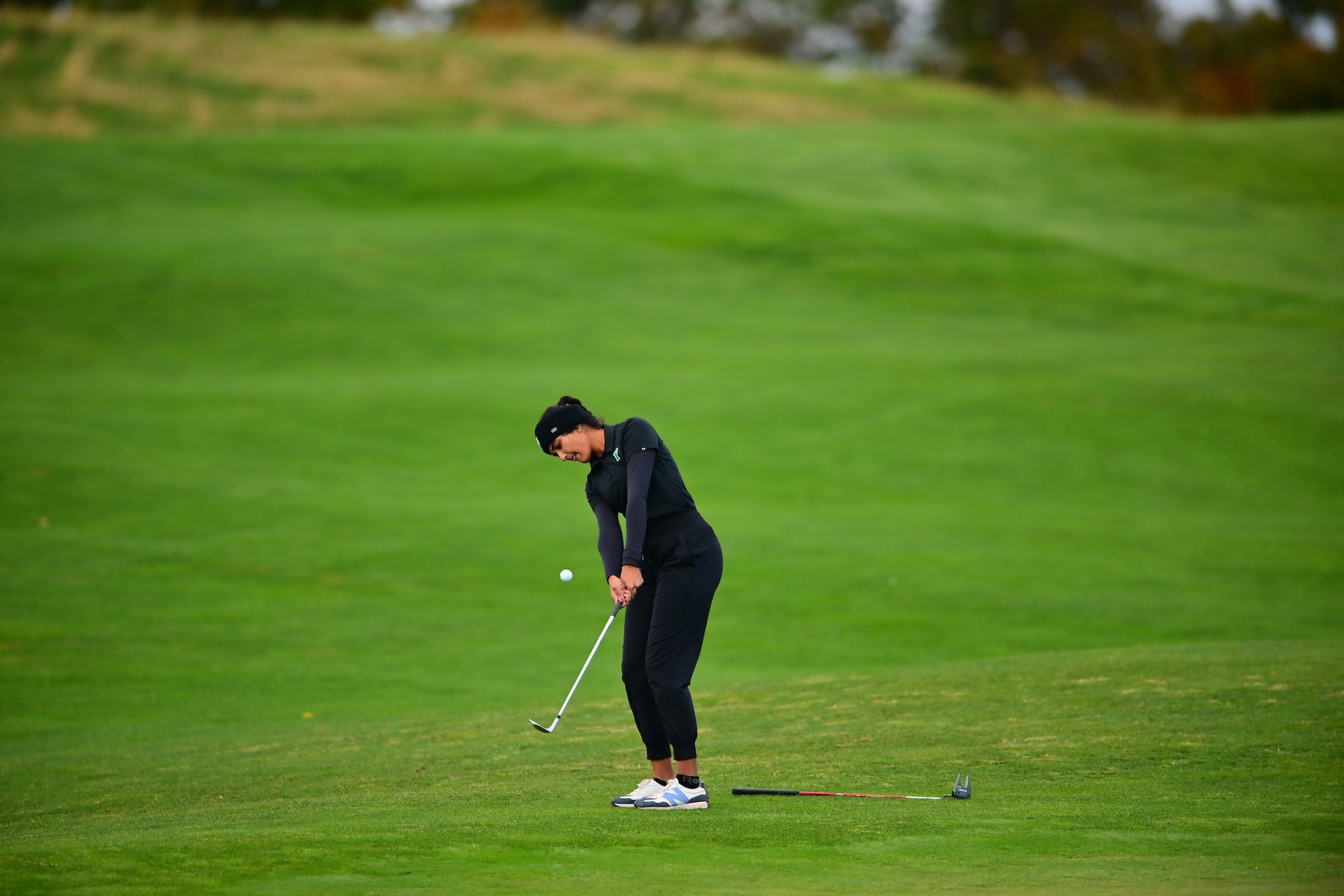 Female hitting golf ball
