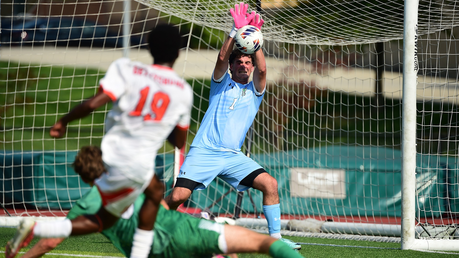 male soccer goalie makes a save